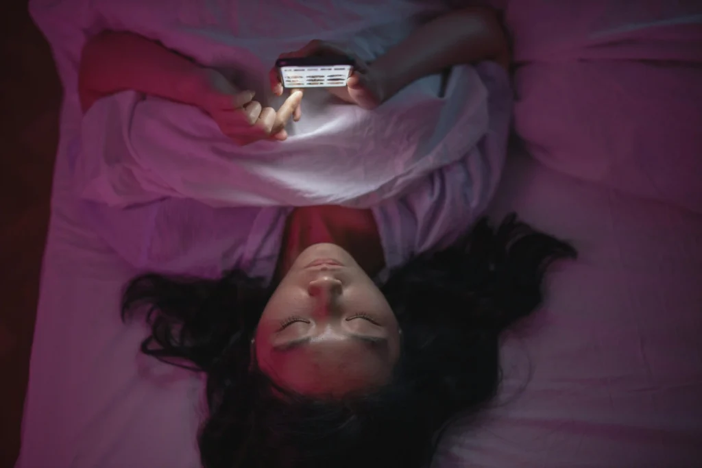 woman on her phone in bed