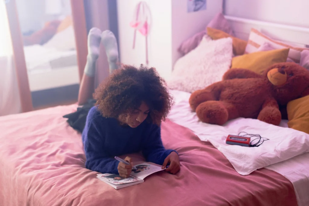 gril journalling on bed